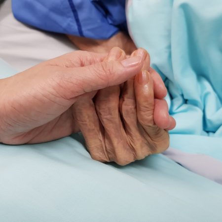 Holding,Grandmother's,Hand,In,The,Nursing,Care.,Showing,All,Love,